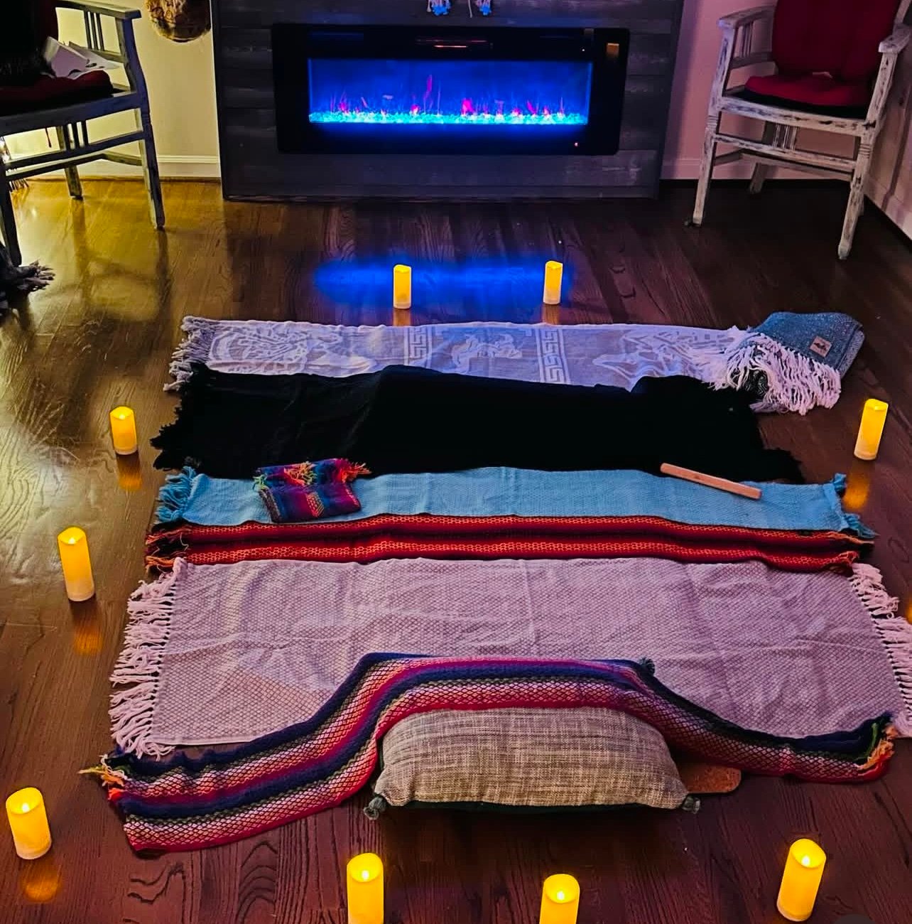 A cozy setup with blankets and candles for a traditional postpartum Closing Ceremony.